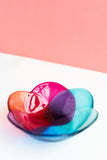 fused glass bowl in a floral shape in shades of pink, peach, purple and blue hand made by people with disabilities