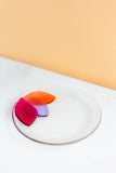 handmade Fused glass appetizer plate with floral petals on one side in pink, orange and lavender made by people with disabilities 