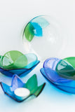 handmade fused glass tableware collection in shades of blue and green with a floral pattern handmade by people with disabilities